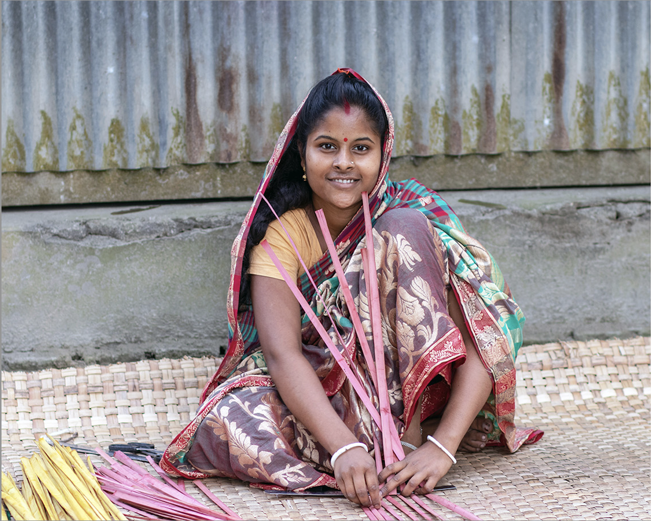 fair trade trades of hope artisan partner dipu in Bangladesh hand weaving and smiling